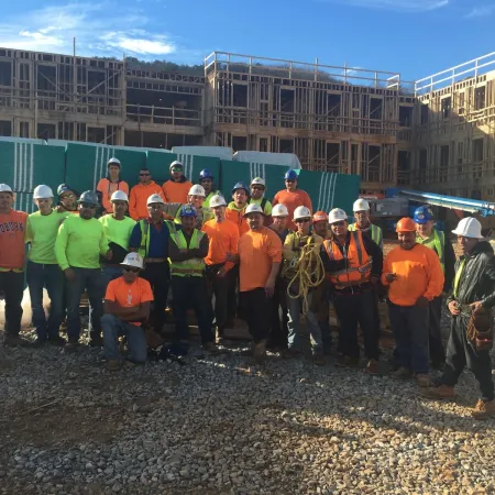 a group of people wearing safety vests posing for a photo