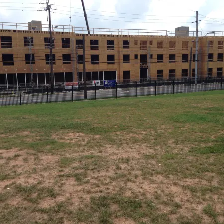 a large building with a fence in front of it