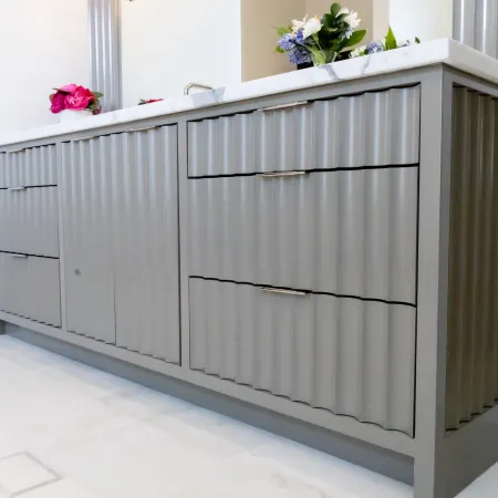 Stylish gray bathroom vanity with ribbed design and elegant accessories