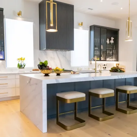 Modern kitchen with marble island, sleek cabinets, and stylish bar stools for a contemporary look.