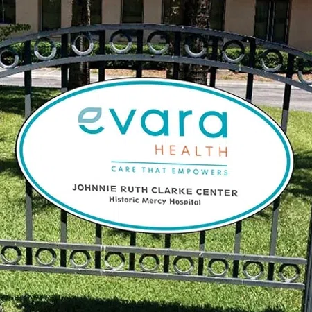 Evara Health sign at Johnnie Ruth Clarke Center outside Historic Mercy Hospital on a sunny day.