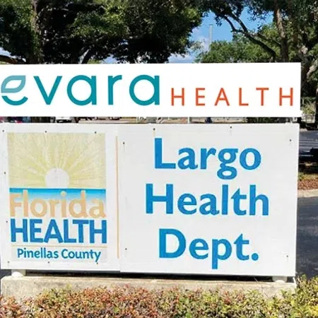 Sign for Largo Health Department and Florida Health Pinellas County with trees and parking lot in background