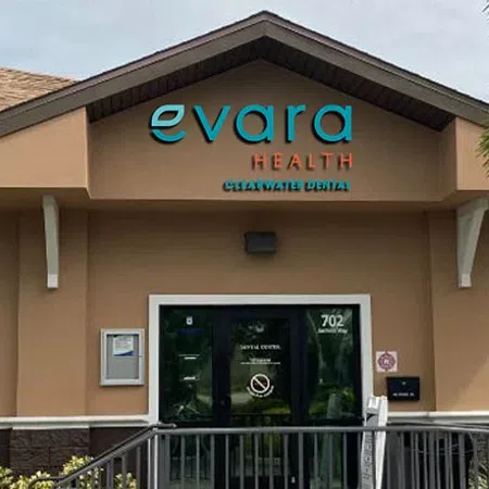 Exterior view of Evara Health Charlotte Dental clinic with signage and entrance door under cloudy sky