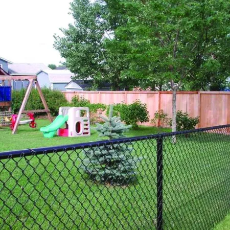 a fenced in yard with a swing set and a slide