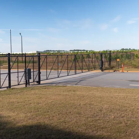 a road with a fence and a truck on it