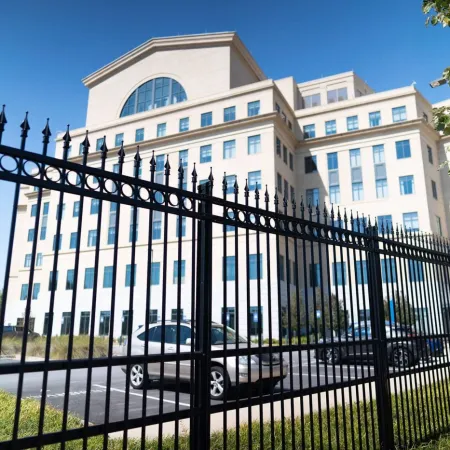 a black fence in front of a building