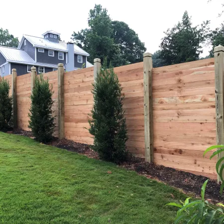 a fenced in yard with a house in the background