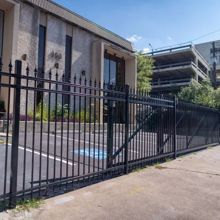 a black gate in front of a building