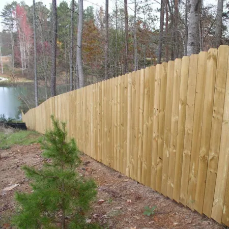 a wooden fence in a wooded area