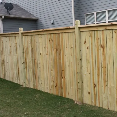 a wooden fence next to a house