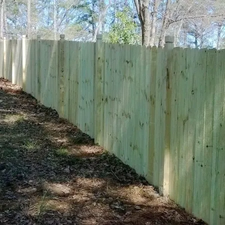 a wooden fence with a dirt path