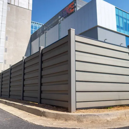 a metal fence next to a building