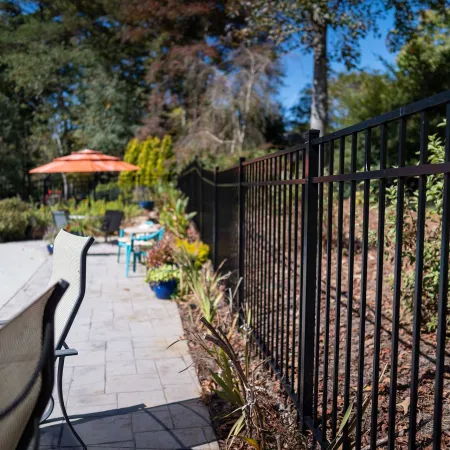 a patio with a fence and a pool