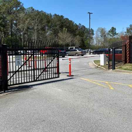 a road with a gate and cars on it
