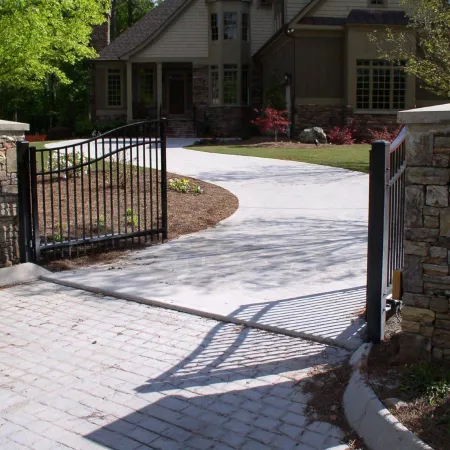 a gated driveway leading to a house