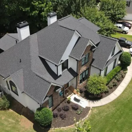 a house with a driveway and cars parked in the driveway