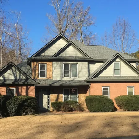 a house with bushes in front of it