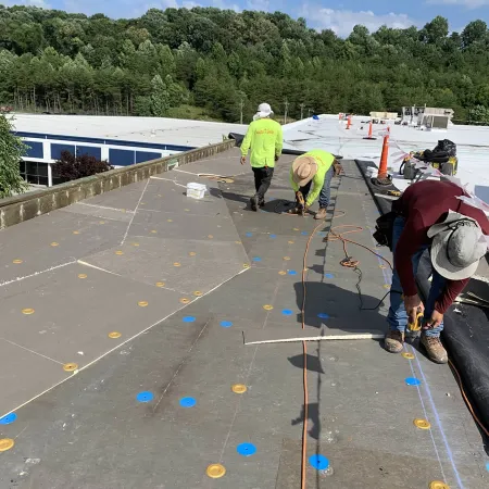 a group of people working on a solar panel