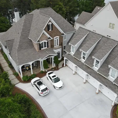 a couple of cars parked in front of a house