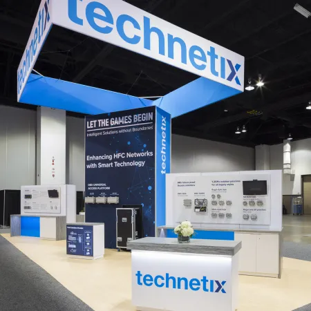 Technetix trade show booth with signage and displays highlighting smart HFC network technology solutions.