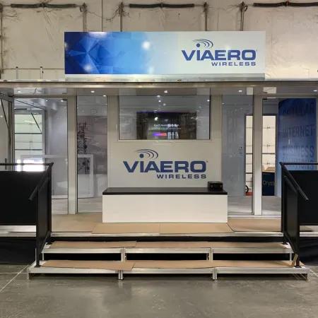 Modern Viaero Wireless promotional kiosk with large glass facade and branded signage inside an event space