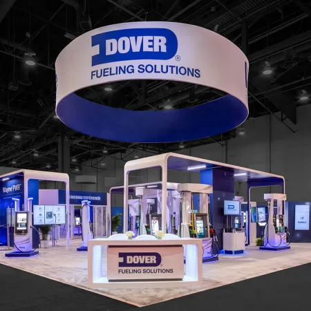 Modern exhibition booth for Dover Fueling Solutions with branded signage and fuel pump displays at trade show.
