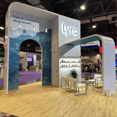 Lyra exhibition booth with blue arch, slogan 'Take a deep breath,' seating area, and modern design at trade show.