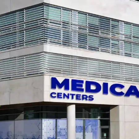 Modern medical center building with large signage reading MEDICAL CENTERS on corner exterior wall.