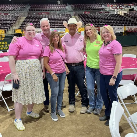 a group of people posing for a photo in a stadium