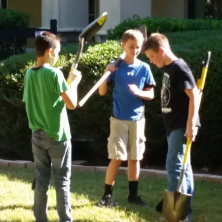 a group of boys holding shovels