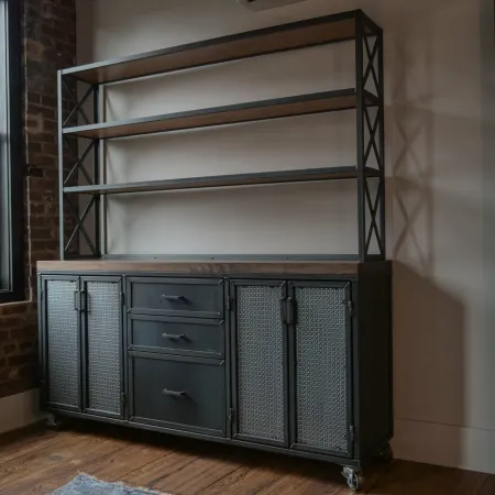 Industrial-style black metal and wood shelving unit with drawers and cabinets in a modern loft room.