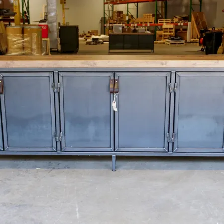 Long blue industrial metal storage cabinet with six doors and leather handles in a warehouse.