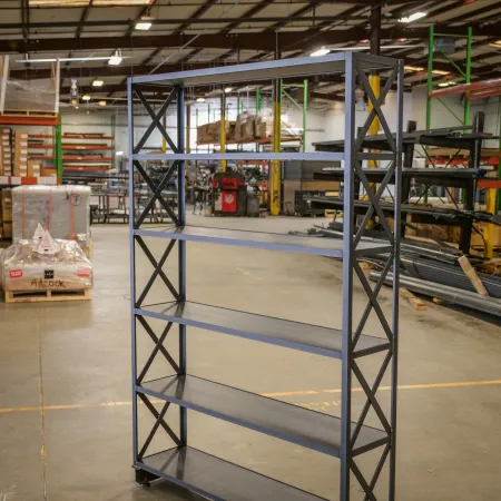 Black metal shelving unit with five shelves in a spacious industrial warehouse setting.