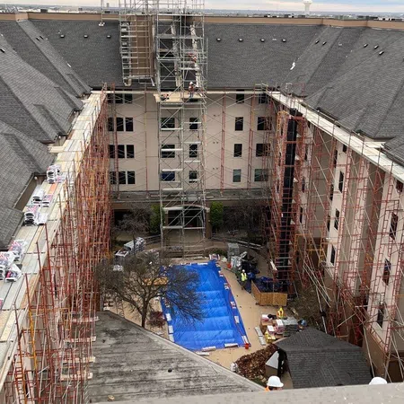 a pool in a courtyard between buildings