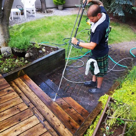 a person using a hose to water a garden