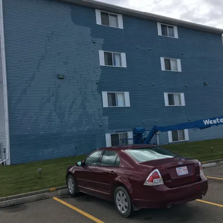 a car parked in front of a blue building