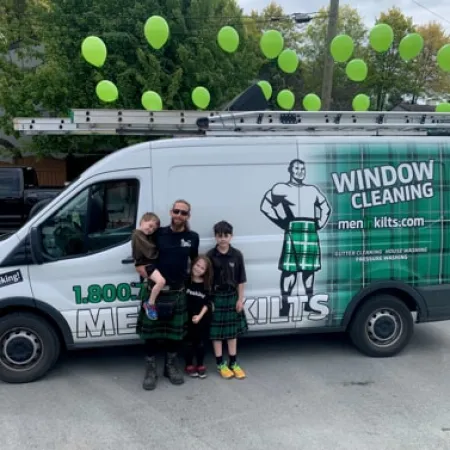 a group of people standing in front of a van with balloons