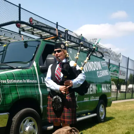 a person in a uniform playing a guitar next to a dog