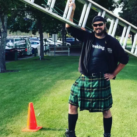 a man in a kilt holding a bow and arrow