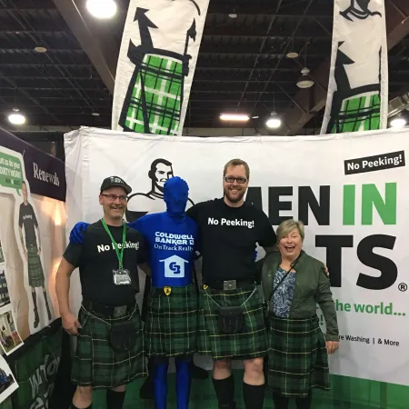 a group of people wearing kilts