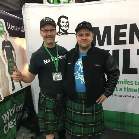 two men wearing kilts