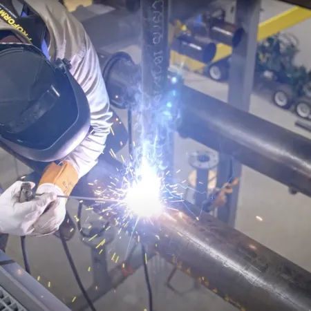 a person wearing a hard hat and protective gear working on a beam