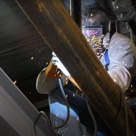 a person wearing gloves and a white glove holding a metal object