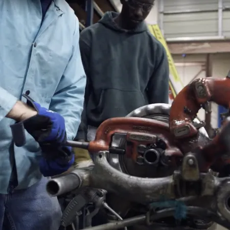 a group of men working on a machine