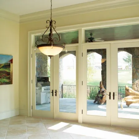 2 white French doors leading onto back patio