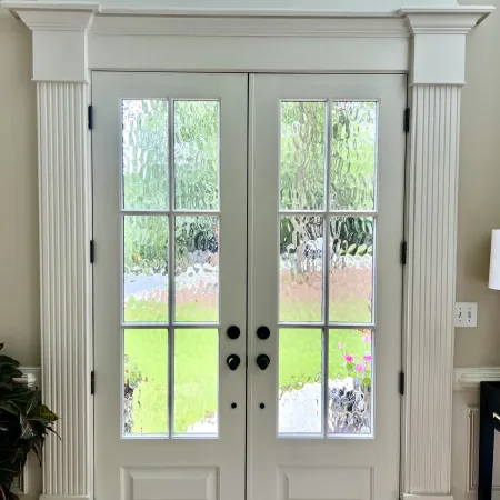 Interior view of double fiberglass front doors with decorative glass