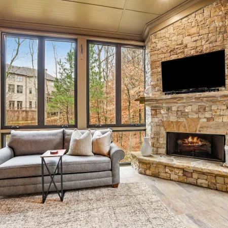 Cozy living room with large bronze casement windows