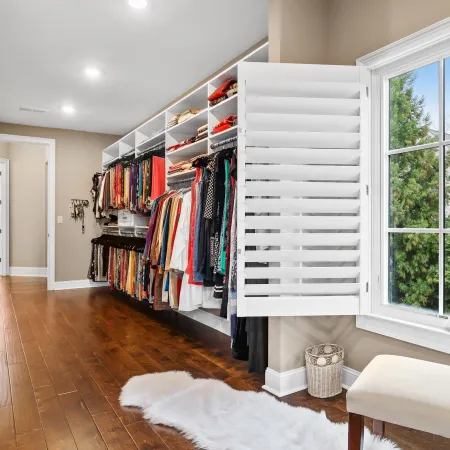 White fiberglass casement window with grids in a walk in closet