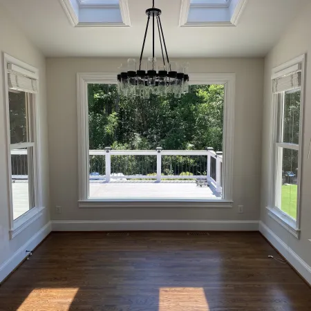 a room with a window and a light from the ceiling