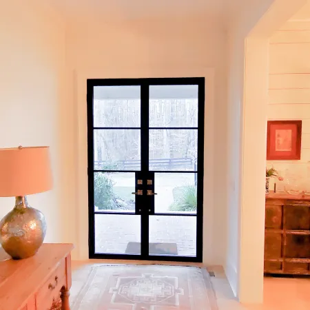 Entryway with modern iron and glass double front doors with black frame